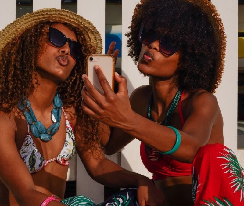 Two Black Women wearing bathing suits taking a selfie